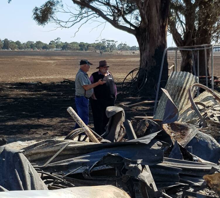 HIGH RISK: Corangamite mayor Neil Trotter inspects fire damage with farmer Ian Grummett. Residents have been urged to attend Wednesday night's meeting.