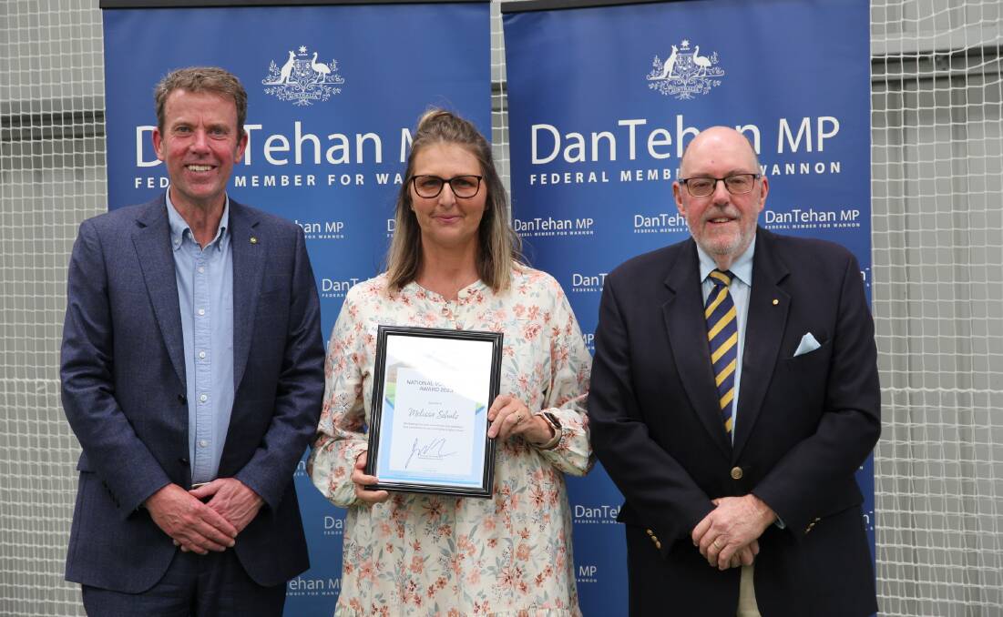 Melissa Schulz, centre, is presented with her award by Dan Tehan and Mick Murphy.