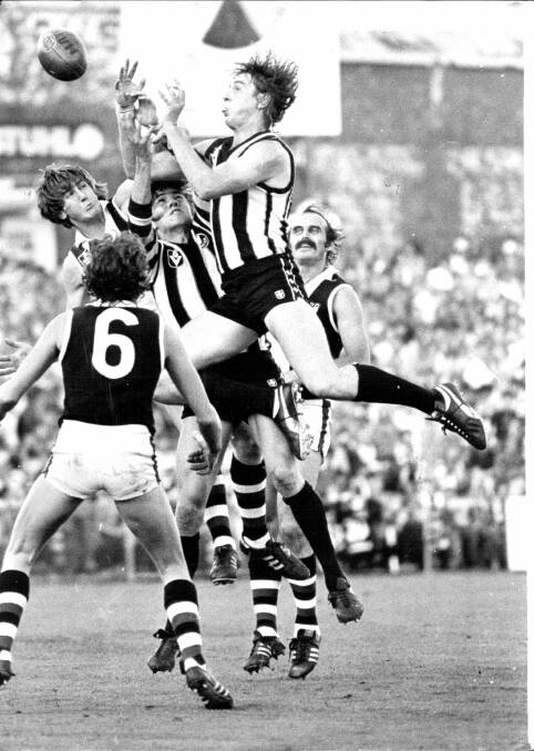LEGEND: Billy Picken flies high above a pack during a match against St. Kilda at Victoria Park in 1980.