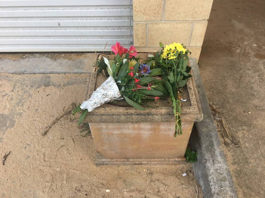 TRIBUTE: Several bunches of flowers have been left at the Port Campbell Surf Lifesaving Club. Picture: Monique Patterson