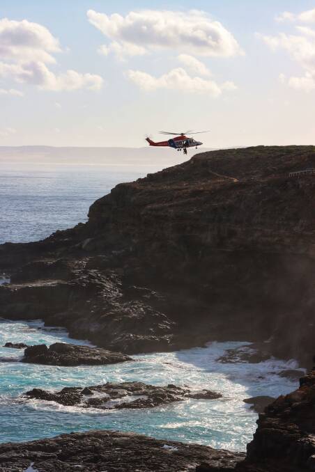 Saved: The winch rescue of a 20-year-old Melbourne man being performed at Green Pools near Cape Bridgewater. Pictures: Henry Rundell