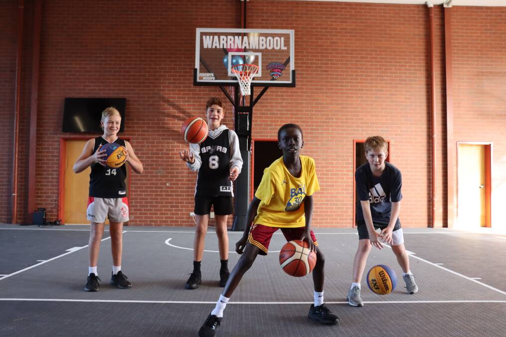 Billy Schrama, 11, Chaz Toki, 12, Gano Akoch, 10, and Roy Lucas, 12, get ready for a FIBA basketball match at the city's old fire station. Picture: Justine McCullagh-Beasy 