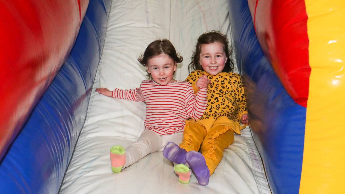 FUN: Georgia Perry, 3, and Elise Perry, 5, rush down their favourite 'fast' slide at Inflatabool in 2019. Picture: Morgan Hancock