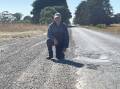 Kevin Bourke stands next to a pothole which he said fills up with water when it rains, more than a decade after he raised concerns about it. Picture by Monique Patterson