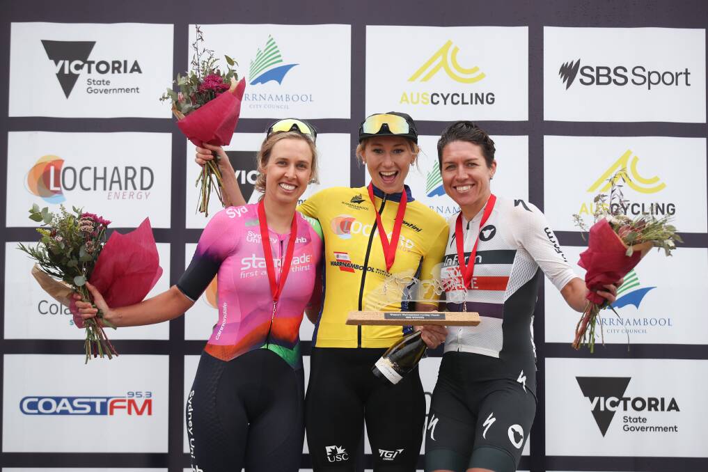 Josie Talbot, Maeve Plouffe and Matilda Raynolds stand on the podium during Warrnambool Women's Cycling Classic presentations. 