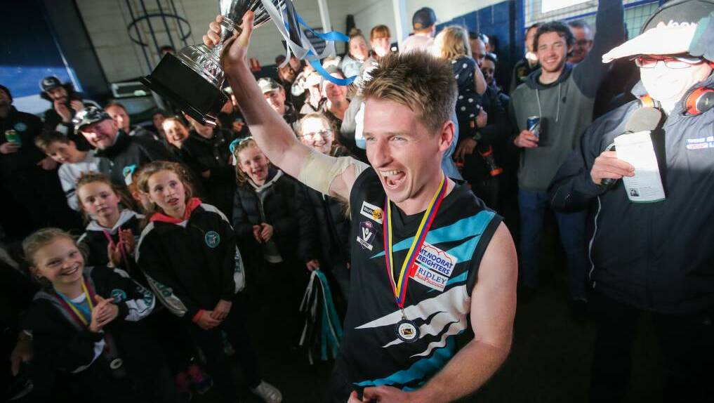 Ben Walsh walks into the club rooms holding the premiership cup. Picture: Morgan Hancock