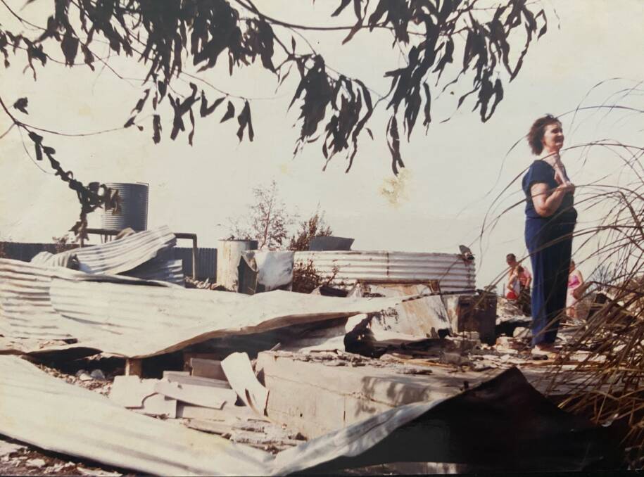 GONE: Kristy's grandmother Bertha Plozza checks out the damage after fired razed homes in Brucknell on Ash Wednesday.