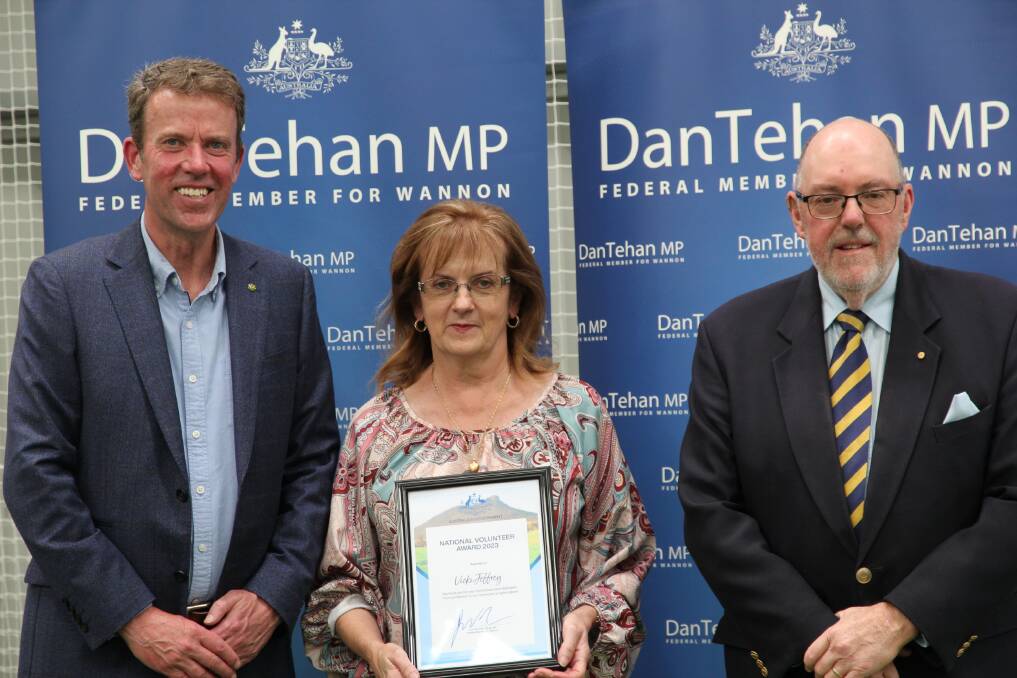 Vicki Jeffrey is presented with her award by Dan Tehan and Mick Murphy.