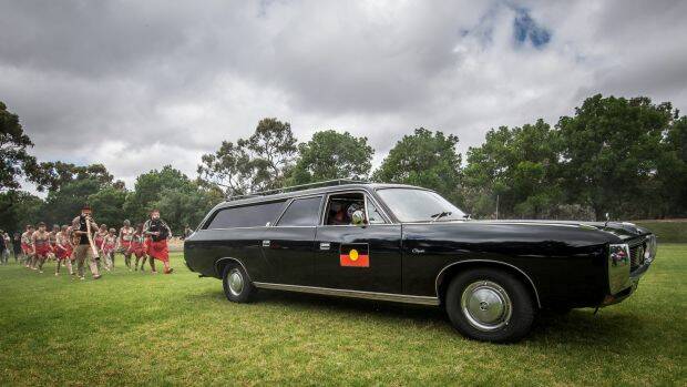 The children of the Tirkandi Inaburra dance group follow the hearse as it arrives in Hay. Photo: Justin McManus