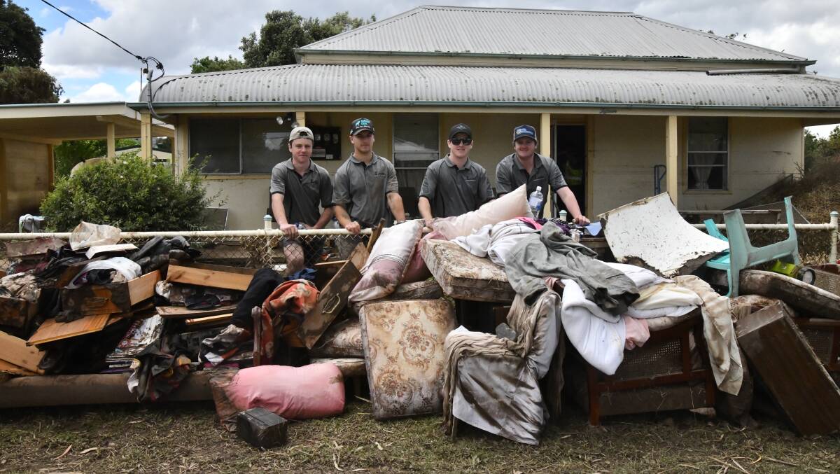 Lachie Nixon, Dylon Ryan, Johnny Vella, Brad Hoadley during the initial clean-up in Eugowra on Wednesday. Picture by Carla Freedman