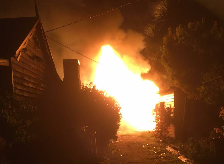 Fully engulfed: The scene at Koroit's High Street early this morning. A bungalow was destroyed. Picture: Anthony Brady