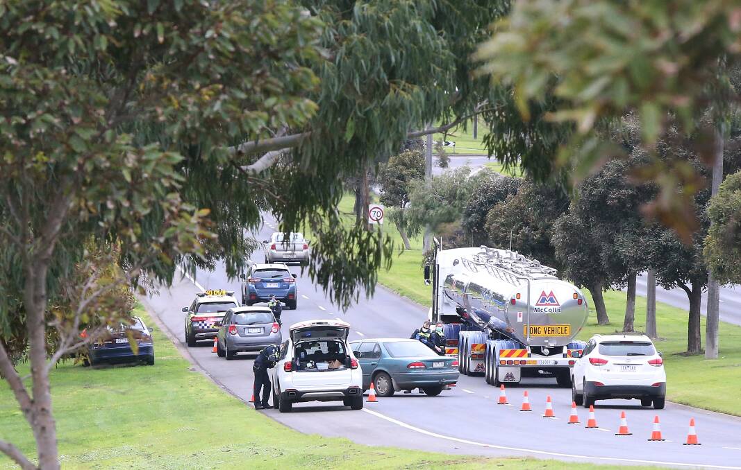 Drivers checked: Police conduct an automatic licence plate recognition based traffic operation on Warrnambool's Raglan Parade Tuesday morning. Picture: Mark Witte