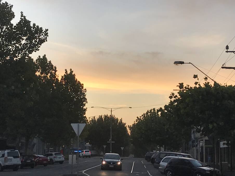 Warm glow: Looking west down Warrnambool's Timor Street at 7.45pm on Monday evening. Today we're expecting a top of 23 in Warrnambool.