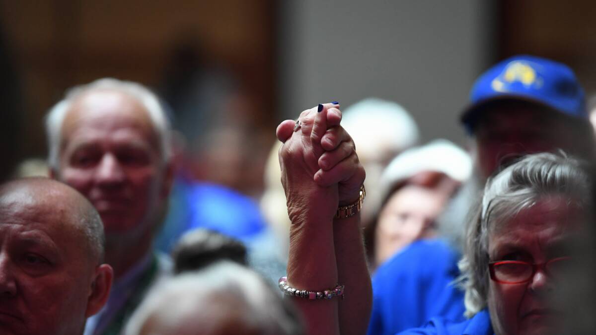 Standing tall: Survivors hold hands as Australian Prime Minister Scott Morrison delivers the National Apology to victims and survivors of Institutional Child Sexual Abuse in Canberra on Monday.