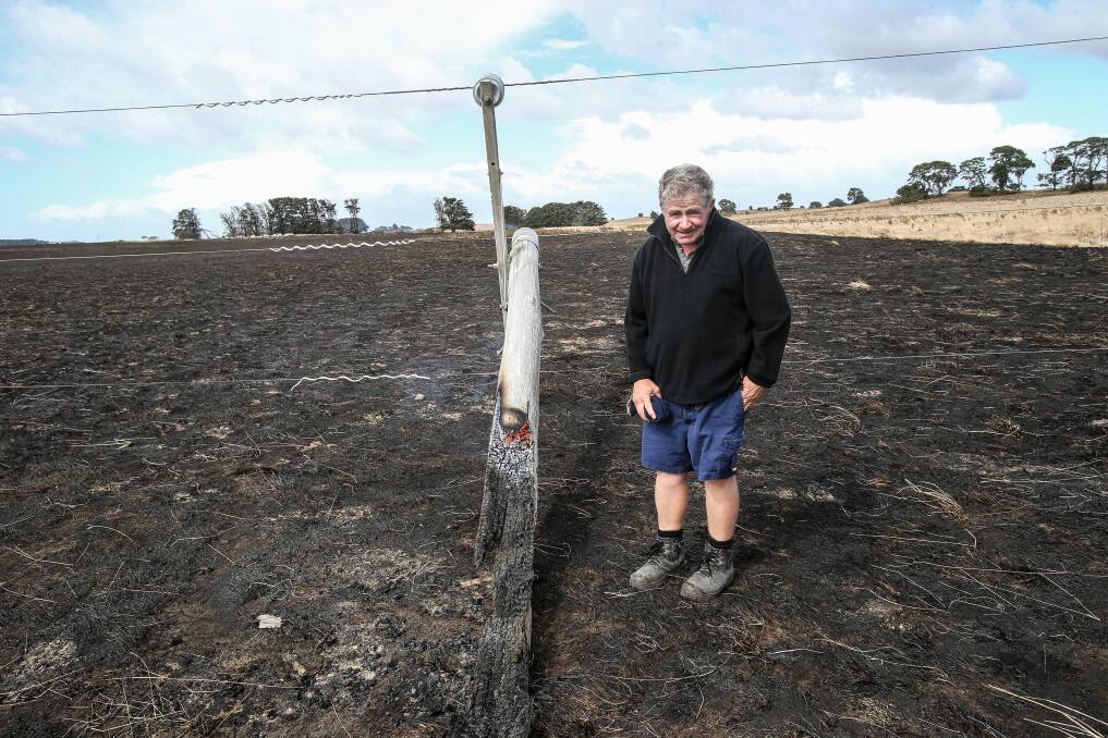Gone: The Sisters farmer Jack Kenna with pole No.4. The rotten section of the pole was destroyed in The Sisters/Garvoc bushfire.