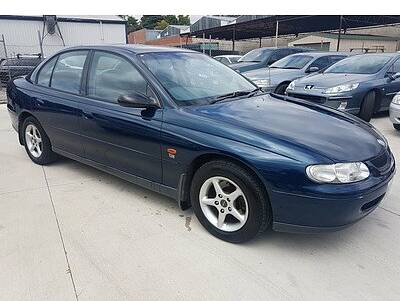 Damaged: A dark blue VT Holden Commodore - similar to this image - crashed through a fence overnight Saturday near the Friendly Societies' Park in Warrnambool .