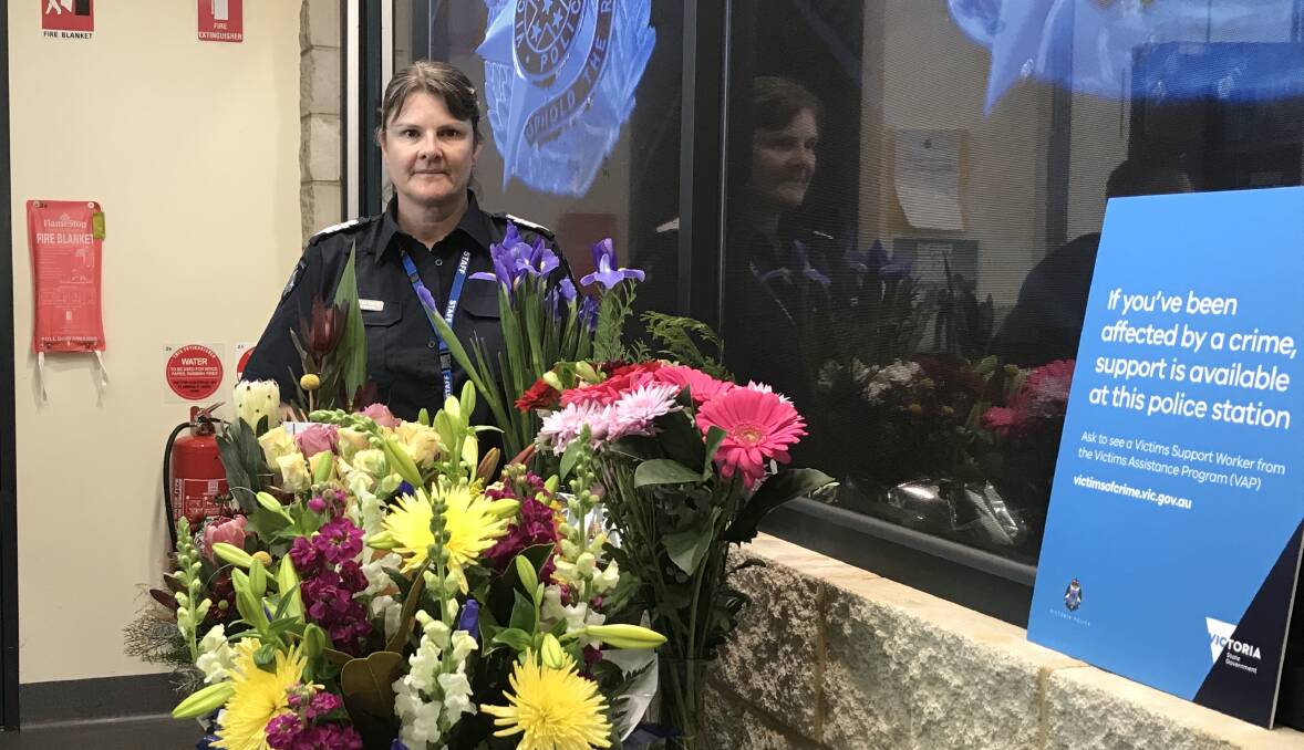 Gratefully received: Warrnambool Senior Sergeant Tania Barbary with some of the flowers community members have sent to the Warrnambool police station after the death of four officers in Melbourne on Wednesday evening. Picture: Andrew Thomson