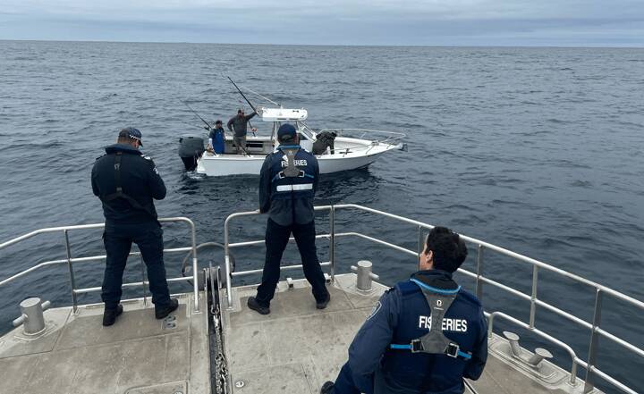 Water police check a boat during the weekend's operation.