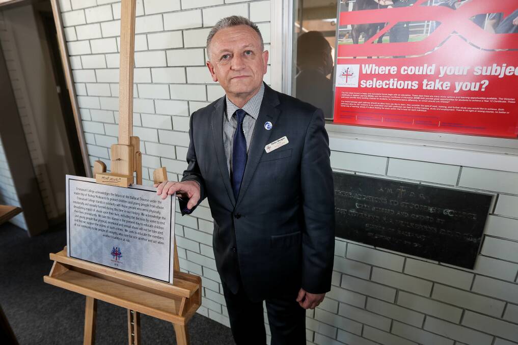 Crucial step: Emmanuel College principal Peter Morgan with the plaque that recognises the past failings of the Catholic Church. Picture: Morgan Hancock.