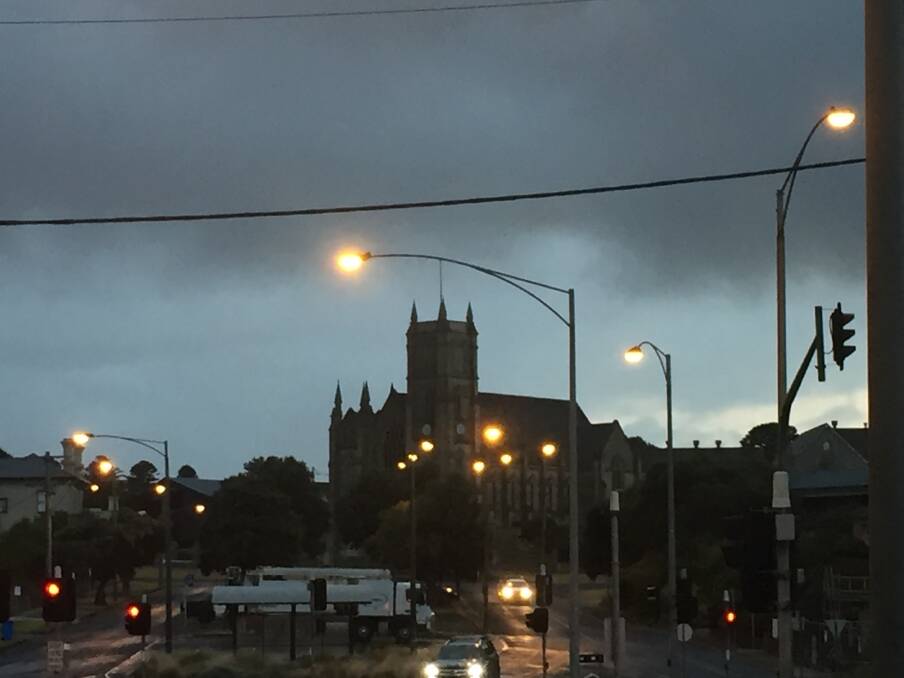 Gloomy: Looking north across the intersection of Raglan Parade and Kepler Street just before 7am in Warrnambool. 