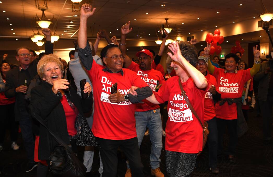 On the way: Labor supporters react during the party reception at the Village Green in Mulgrave on Victorian State election night in Melbourne.