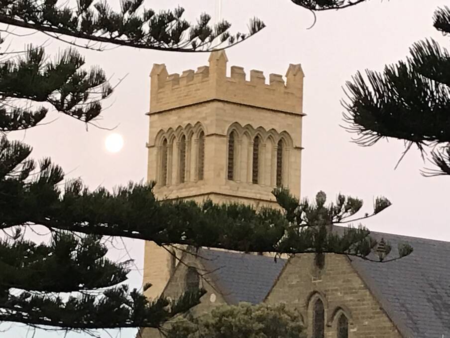 Peeping through: The moon beside the Anglican Church at the Warrnambool intersection of Koroit and Henna streets about 8pm Tuesday night. Today Warrnambool is expecting a top of 23 degrees.