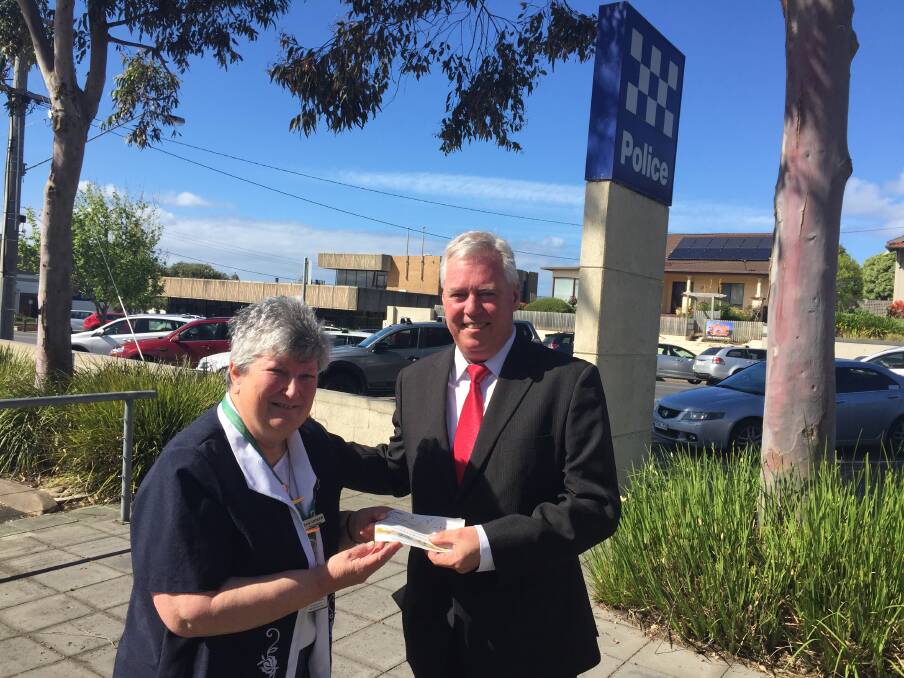 Chipping in: CWA group and Warrnambool president Pam Andrew hands over about $500 to Warrnambool police Senior Sergeant Shane Keogh in support of the Head to Head walk.