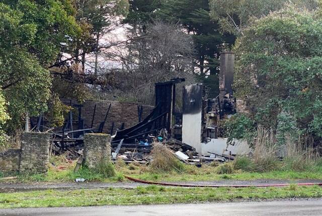 Wrecked: The scene of the house fire in Hamilton this morning. Police say the cause of the blaze is suspicious.