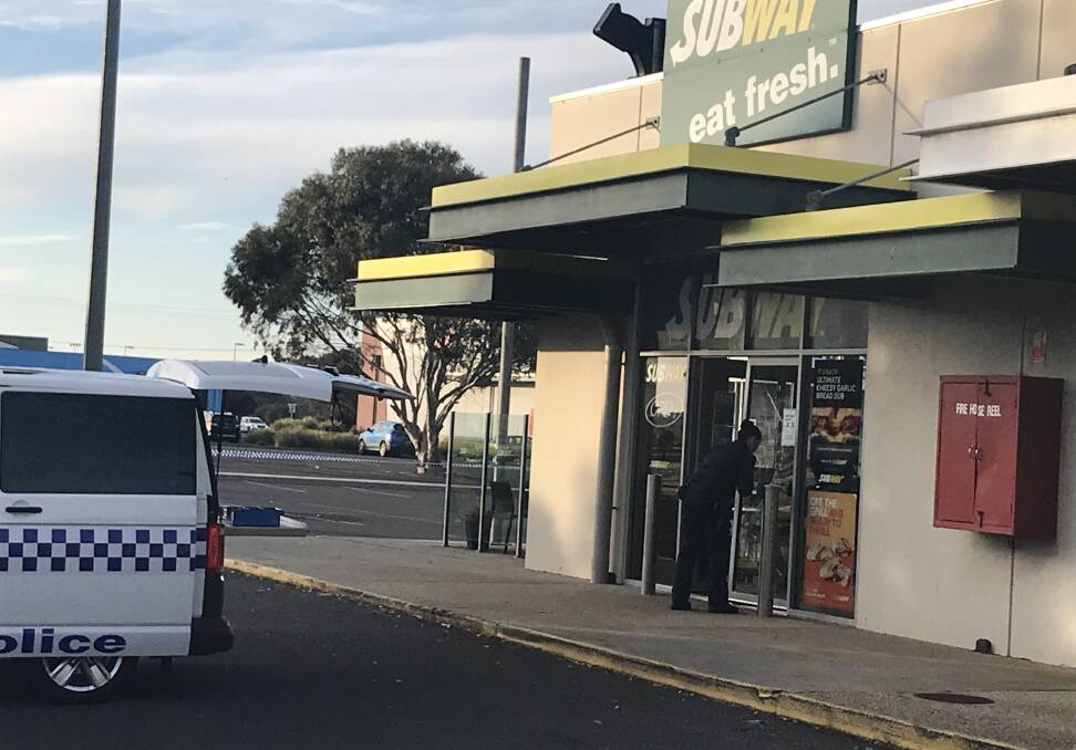 A police officer does forensic tests at the Subway restaurant in east Warrnambool on June 12. The tests led to an offender being identified.