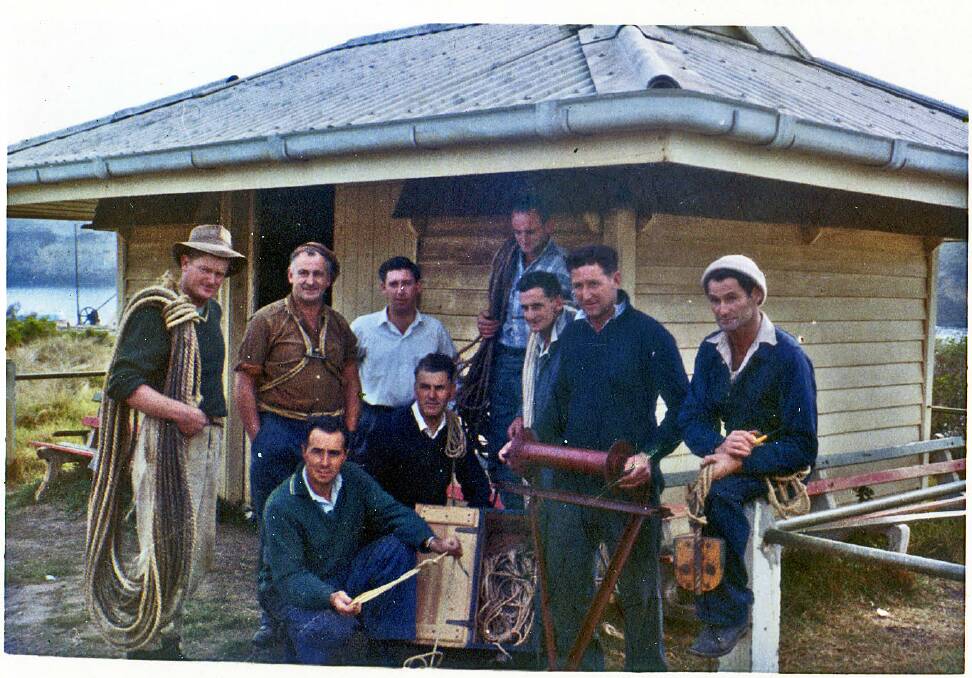  Foundation members of the Port Campbell Cliff Rescue Squad. Standing from left: Don Baird, Frank Coxon, Ron Street, Barney Hunter, Jack Coxon, Bill Neal and Norm Neal. Squatting from left John Knox and Constable Duncan Hales. The photo was taken in front of the Port Campbell rocket shed, where the original rocket equipment was housed and where the cliff rescue squad stored its gear.