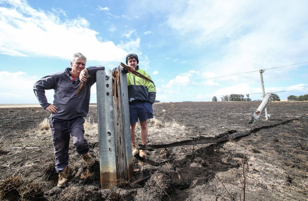 Bernie Harris and Jack Kenna jnr with the pole that snapped and caused The Sisters/Garvoc bushfire. The last inspection of the pole - less than four months before the fire - took just 90 seconds.