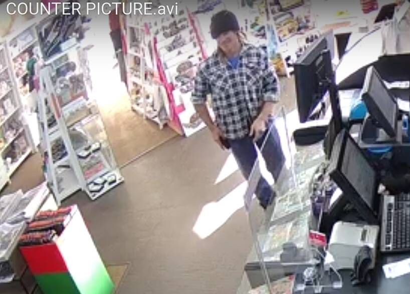 A smiling Travis Cashmore buying Tattslotto tickets in the Koroit newsagency less than half an hour before he shoots and runs down career criminal Kevin Knowles and his sidekick Benny Ray.