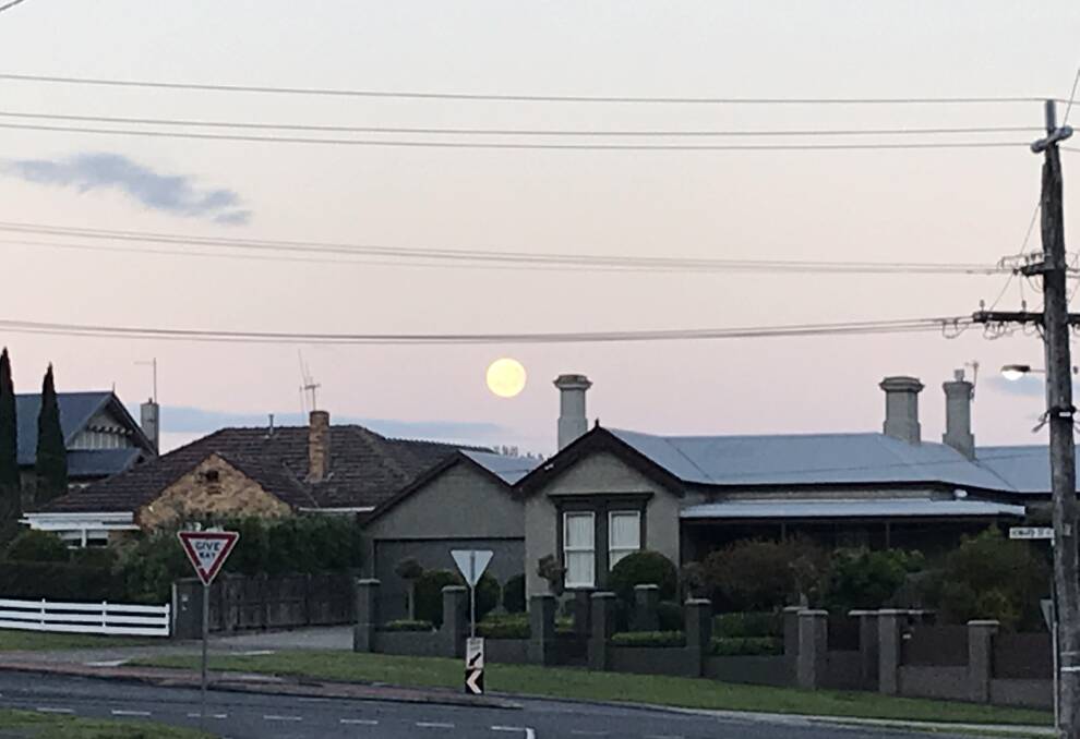Lunar glimpse: The moon was dropping quickly just before 7am this morning at the intersection of Howard and Banyan streets in Warrnambool.