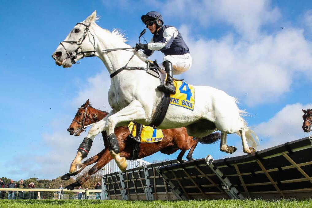 Too good: Flemington odds-on hope Valac (Tommy Ryan) clear a hurdle in the opening race at Warrnambool on Thursday. Picture: Morgan Hancock.