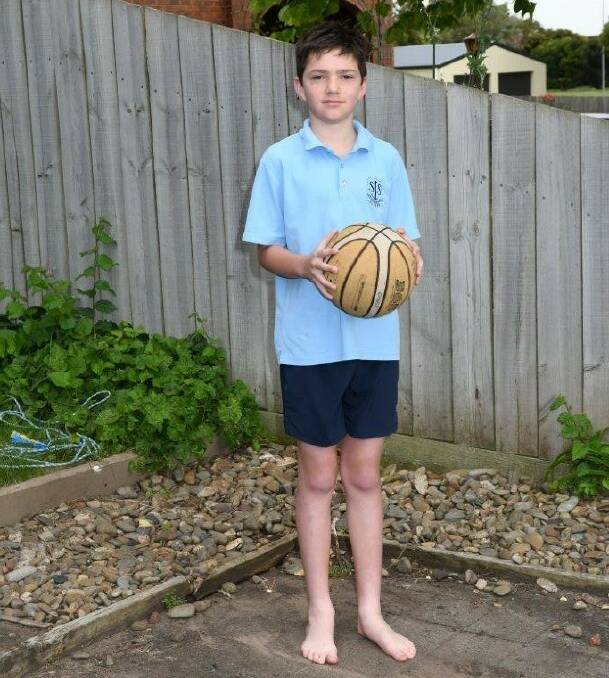 Gone: Paddy Sell, 10, has a basketball but no ring after thieves stole it overnight on Saturday.