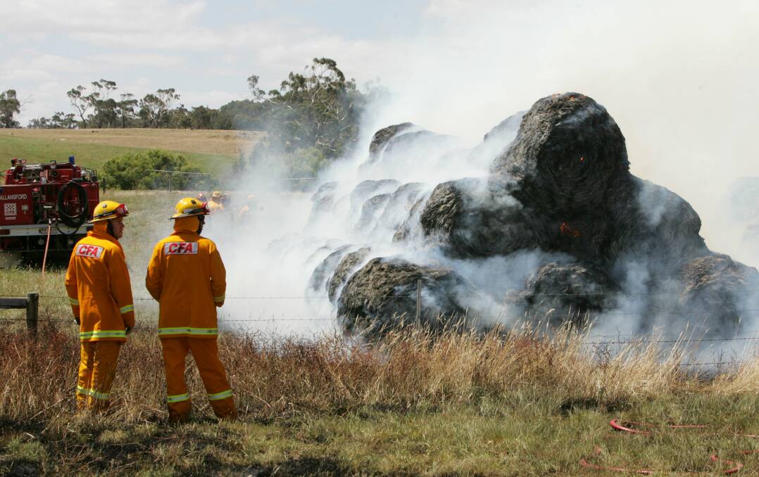 EMERGENCY: A firefighter works on a haystack fire from another incident.