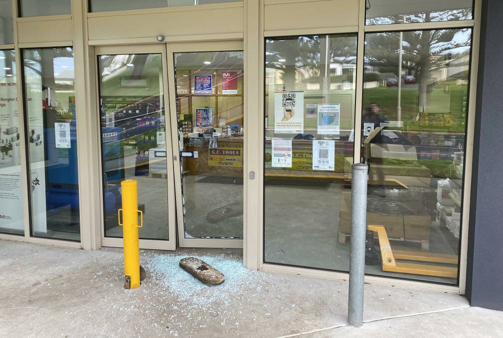 Busted: A concrete pit cover was used to smash the front glass door of the business.