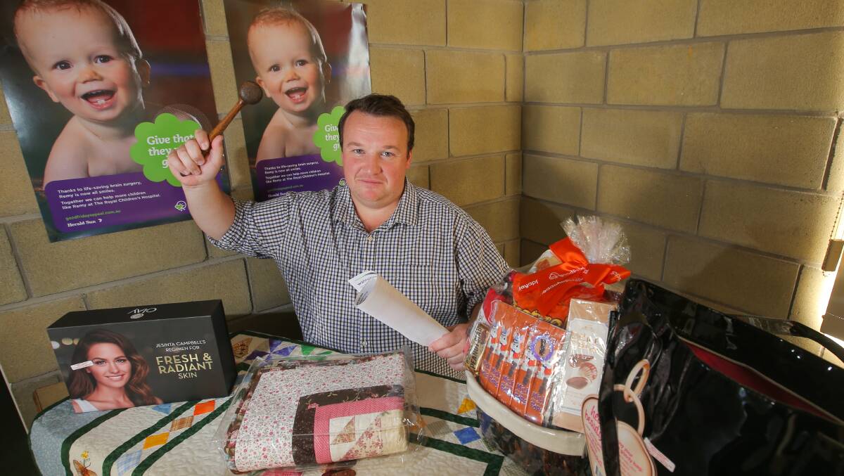 Opted out: Garvoc resident and Warrnambool solicitor Adam Bellman with some of the items that were auctioned off for the annual Good Friday appeal. He's opted out of a legal class action as a victim of the St Patrick's Day fires.