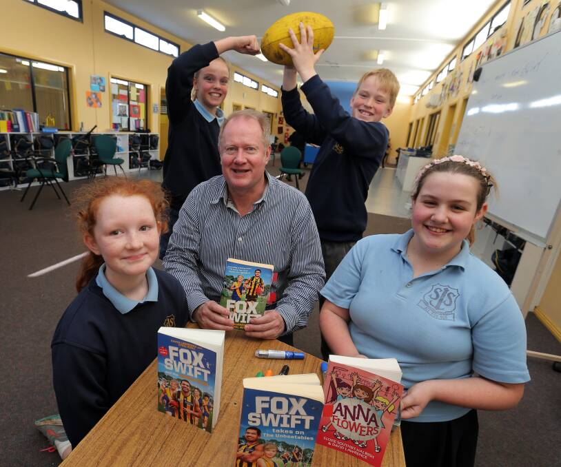 STORY TIME: Author David Lawrence with some of his readers at St Joseph's Primary School - Tayla Curran, Sascha White, Darcy Barker, and Eliza Healey. Picture: Rob Gunstone
