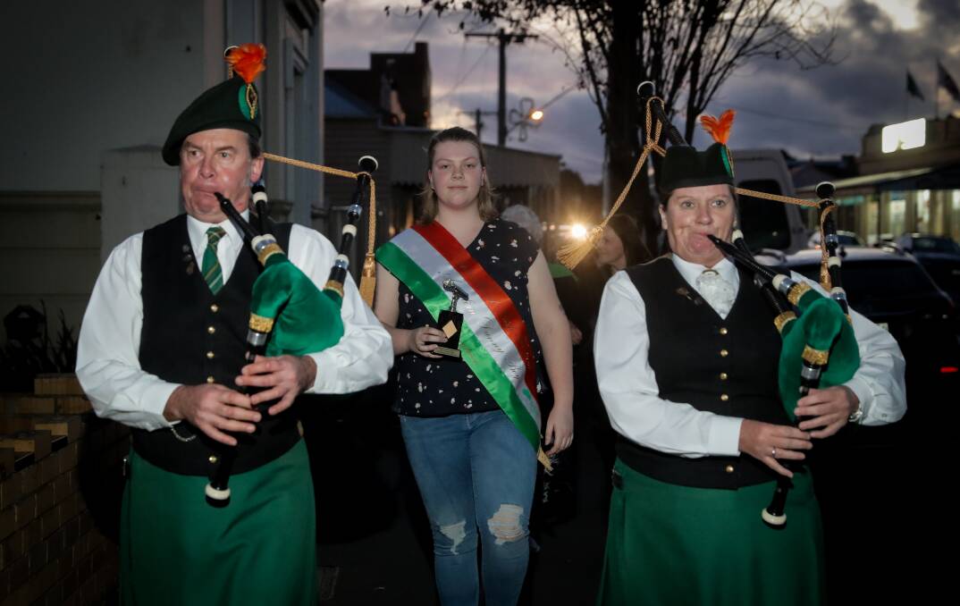 THE PIPES ARE CALLING: 2018 Danny Boy competition winner Gabby Steel, 18, from Warrnambool, is piped along Commercial Road in Koroit, to perform a rendition of the song at Mickey Bourke's Pub. Picture: Rob Gunstone