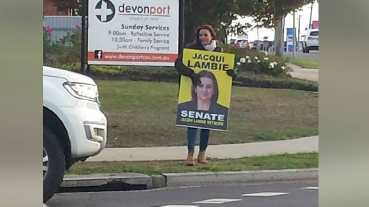 Senate hopeful Jacqui Lambie stands by the roadside at the KFC roundabout in Devonport. 