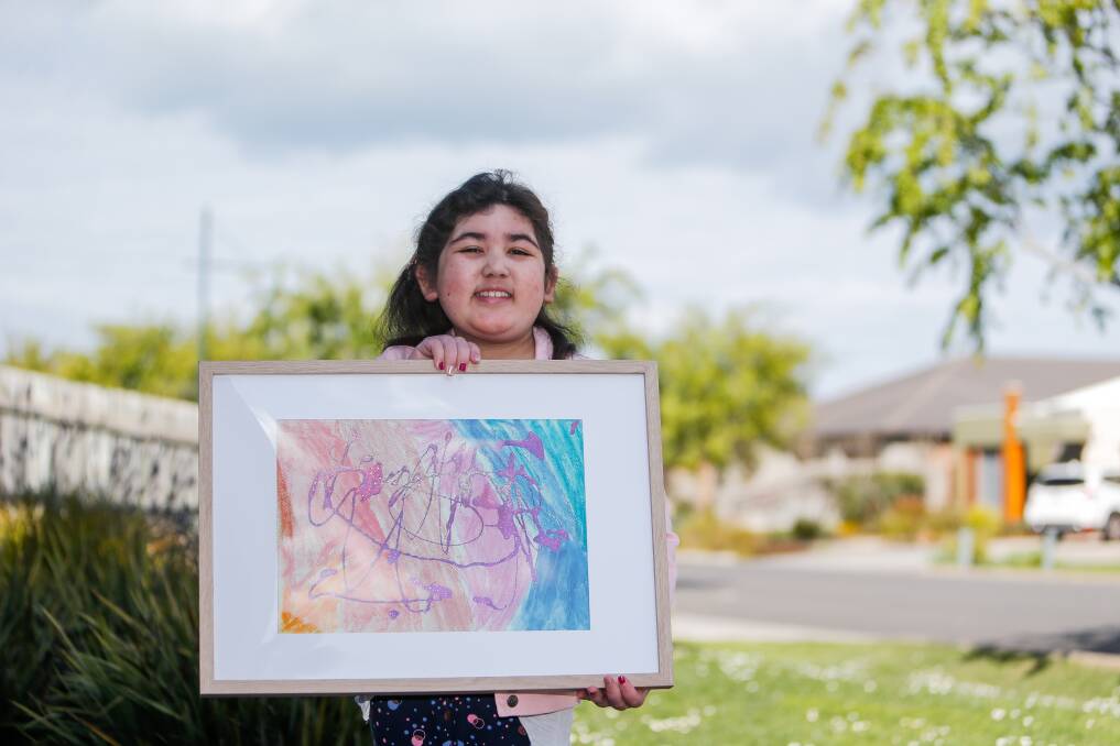 JOY: Naomi Philpot with part of the artwork published by The Lancet medical journal. Naomi recently underwent three emergency surgeries. Picture: Anthony Brady