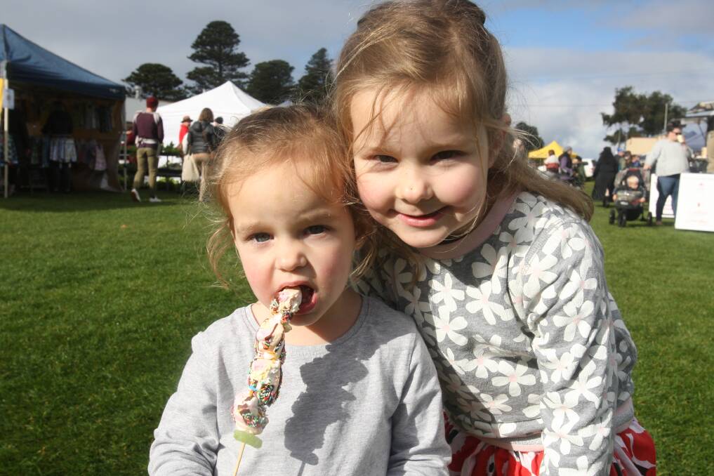 FUN: Port Fairy's Ruby Church, 2, and Piper Church 4, enjoy a morning out at the Port Fairy Community Market on a Winter Weekend. Picture: Jackson Graham