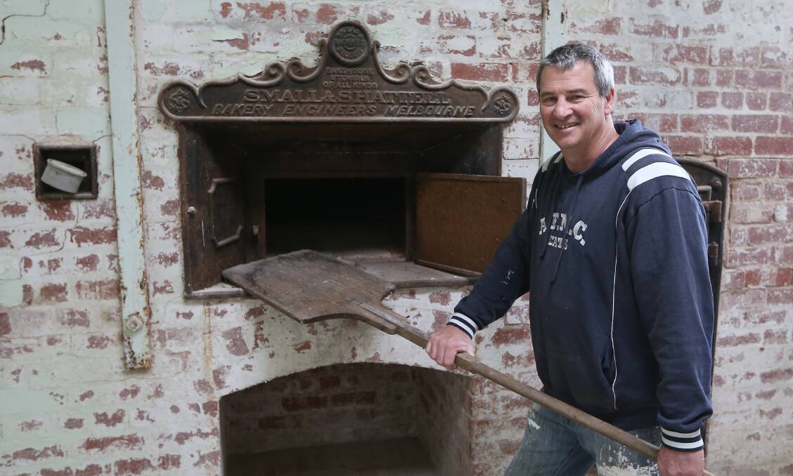 REIGNITING THE FIRE: New Allansford bakery owner Warren Keane stands at the original oven from when the building was previously a bakery. Picture: Mark Witte