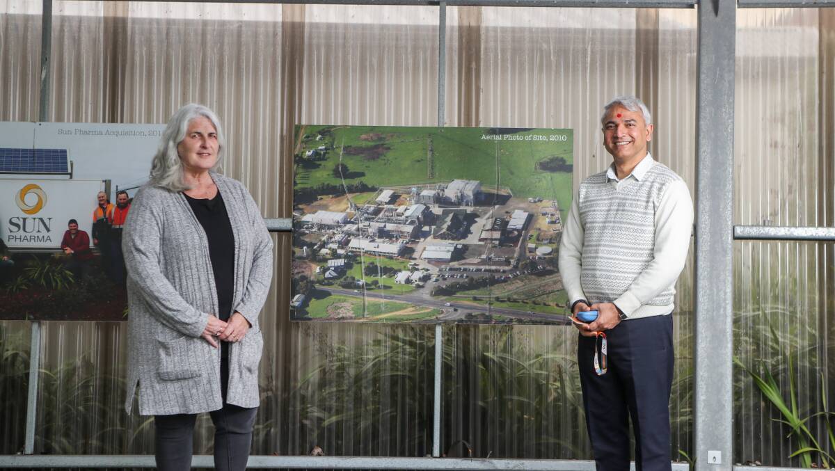 CELEBRATING: Sun Pharma's Louise Nagle and chief financial officer Urvish Bhavsar pose with historical at the plant in its 100th year. Picture: Morgan Hancock