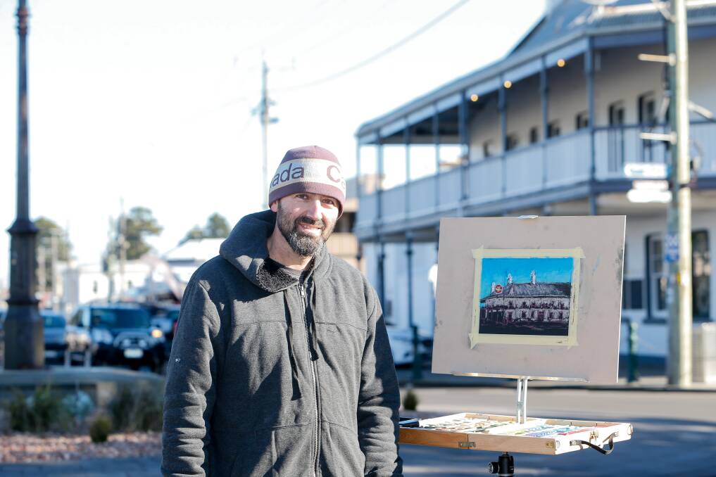 WINTER SCENE: Artist Ricky Schembri paints the Star of the West on Sackville Street at the Port Fairy Winter Weekends. Picture: Anthony Brady