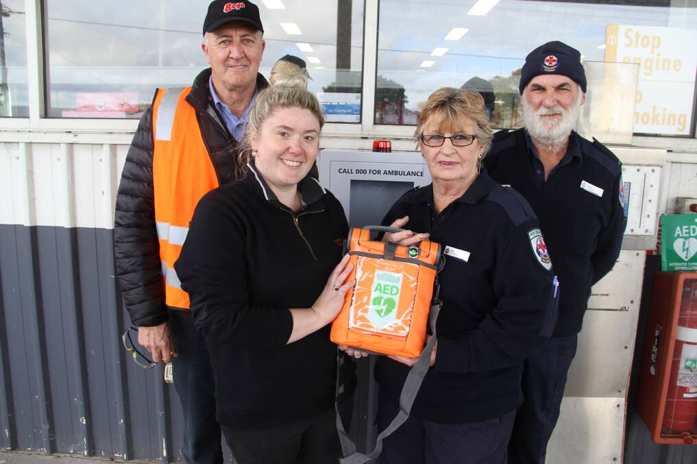 HANDOVER: Murray Goulburn Trading Store's Nerissa Edwards, left, and first responder Ros Stewart with a new defibrillator that will be available to the public in Koroit. Pictured behind is Michael Meade, left, and Steve Stewart.