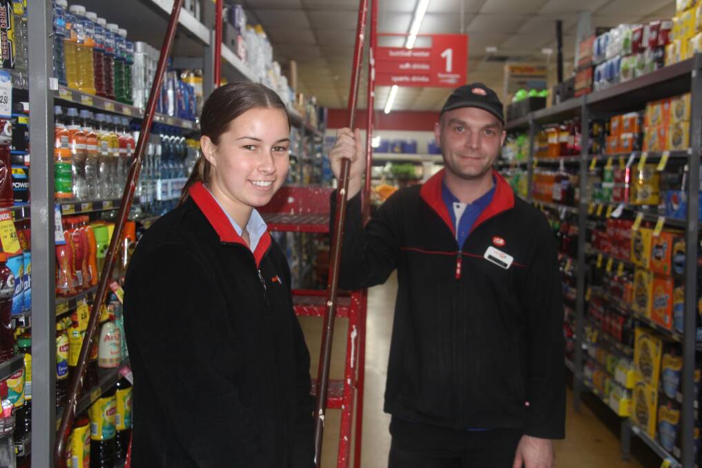 BALANCING ACT: High school student and IGA store attendant Alice Kelly and grocery manager Chris Marsland. A new study has found about 80 per cent of Warrnambool high school students are working. Picture: Jackson Graham