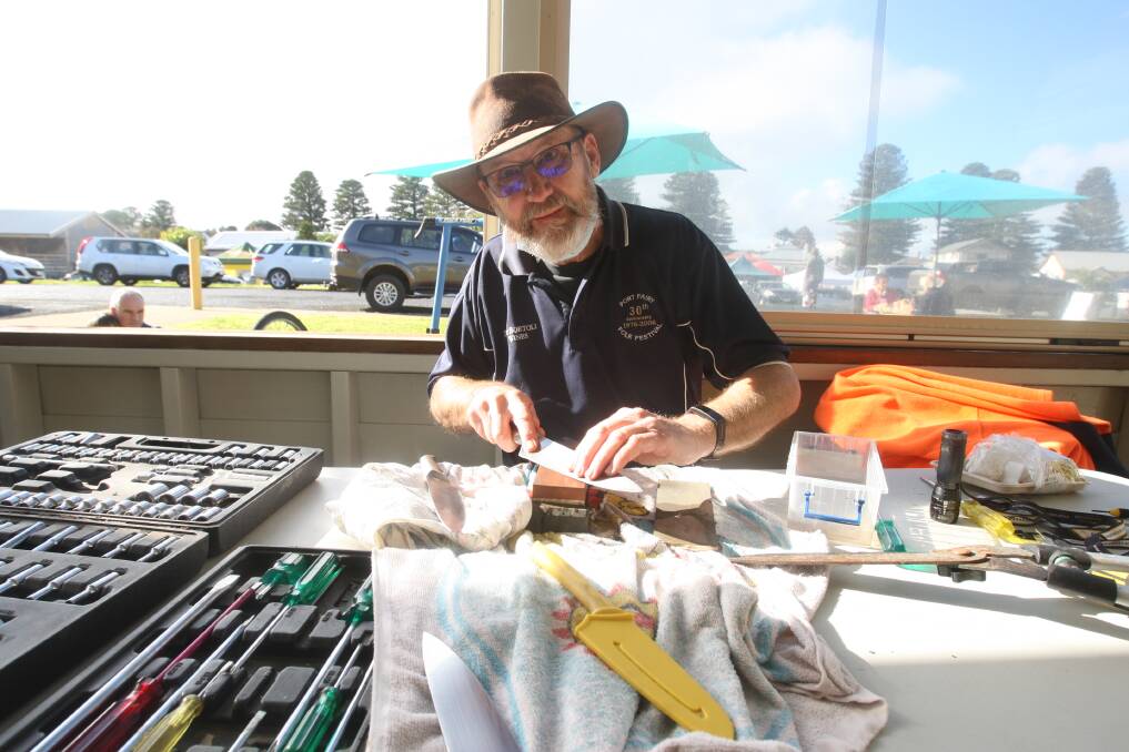 MR FIX-IT: Port Fairy repair cafe volunteer Bari Whitehouse was sharpening people's knives and scissors and fixing household items for community members as part of Winter Weekends. Picture: Jackson Graham