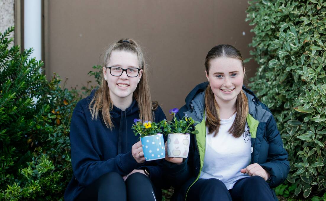 GROWTH: Brauer College students Kayla Neave and Macie Taylor with plants they received from their first day back at school following three weeks of remote learning. Picture: Anthony Brady